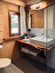 a bathroom with a sink and a toilet at Bieszczadzkie Chatki - Willa Stasia in Ustrzyki Dolne