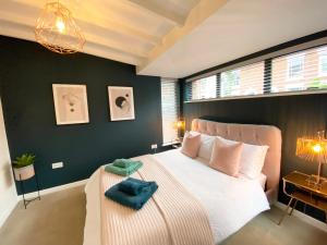 a bedroom with a large bed with two towels on it at The Old Bakery in Norwich