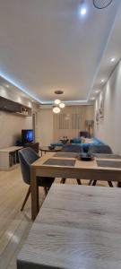 a living room with couches and tables in a room at City apartment in Podgorica