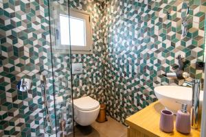 a bathroom with a toilet and a sink and a shower at Luxury House - Hersonissos Center - Sleeps 8 in Hersonissos