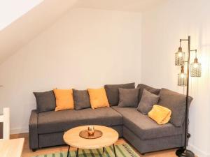 a living room with a gray couch and a table at Cozy seaside hideaway with free parking in Torquay