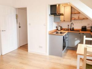 a kitchen with a sink and a counter top at Cozy seaside hideaway with free parking in Torquay