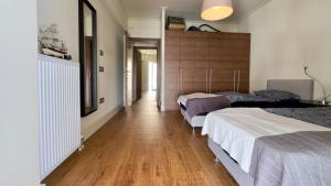 a bedroom with two beds and a wooden floor at Captains 2-Bedroom Suite in Athens Nea Smyrni in Athens