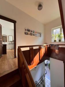 a view of a room with a staircase and a hallway at Charmante Art Deco rijwoning in Ostend