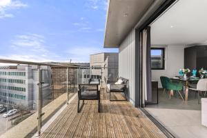 a balcony with a table and chairs on a building at Beautiful Chelmsford Penthouse with Balcony in Chelmsford