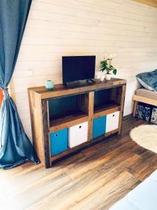 a wooden shelf with a computer on top of it at Farma Náhlov in Frymburk