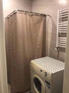 a washing machine in a bathroom with a shower at bakuriani didveli rezidensi G6 in Borjomi +5 photos