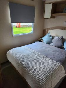 a bedroom with a large bed with a window at regent bay in Morecambe