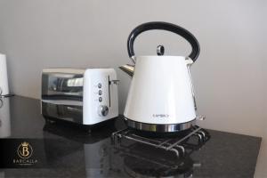 a slow cooker and a toaster on a counter at Barcalla Hotel Apartments in Maseru