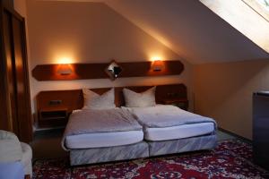 a bedroom with a bed with two lights on the wall at Hotel Plovdiv in Berlin