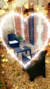 a backyard with a heart made out of lights at Les Almadies private Jacuzzi in Villeneuve-les-Sablons