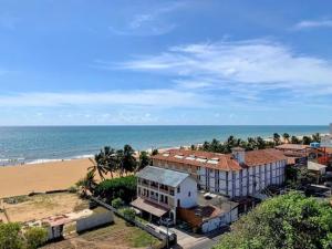 een gebouw naast een strand met de oceaan bij Ocean Breeze Apartment Negombo, R 5, B16 Mina in Negombo