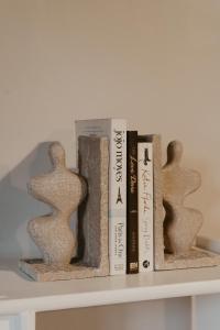 a shelf with books and sculptures on it at Stacey's Apartment in Hillcrest