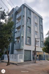 um edifício de apartamentos alto na esquina de uma rua em StayMazing Manyata-1BHK Boutique AC Apartments -Couple Friendly em Bangalore