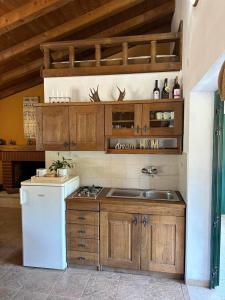 a kitchen with a sink and a white refrigerator at Kuća za odmor Samograd in Žrnovo