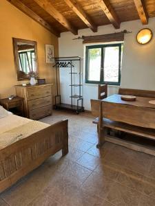 a bedroom with a bed and a dresser and a window at Kuća za odmor Samograd in Žrnovo