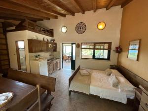 a bedroom with a large bed and a kitchen at Kuća za odmor Samograd in Žrnovo