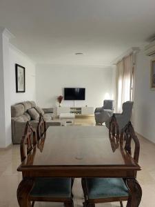 a living room with a table and chairs and a couch at El Paseíllo in Priego de Córdoba