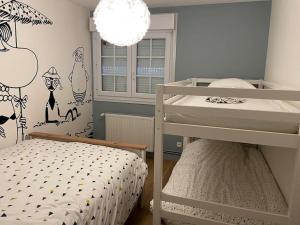 een kleine slaapkamer met een stapelbed en een kroonluchter bij Jolie maison à Equihen-Plage in Équihen-Plage