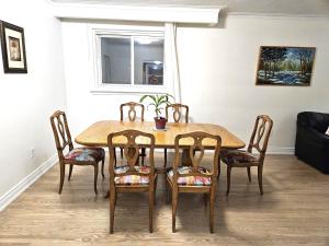 a dining room table and chairs in a room at Charming 3 bedrooms detached house near the airport in Mississauga