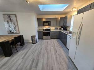 a large kitchen with a table and a refrigerator at White Tail Run At Heron Hill Retreat Hot Tub Lake! in Streetsboro +20 photos