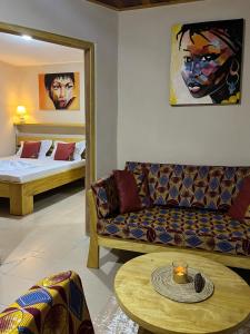 a living room with a couch and a bed at RKS - Résidence Kribi Soleil in Kribi
