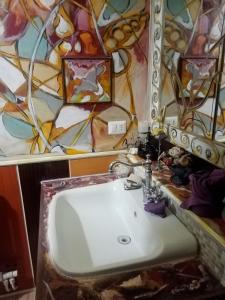 a bathroom with a sink and a mirror at La Casetta Di Anna in Castel Lagopesole +48 photos