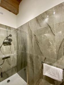 a bathroom with a shower with a glass door at Presqu'ile Saint Nizier coeur de Lyon classé 4* in Lyon