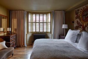 a bedroom with a large bed and a window at The George In Rye in Rye