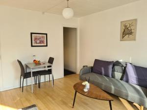 a living room with a couch and a table at Bayer Apartments Copenhagen in Rødovre