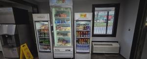 two refrigerators in a store with drinks in them at Super 8 by Wyndham Asheville/Biltmore in Asheville