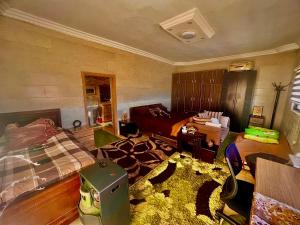 a living room with a bed and a room with a bed sqor at Oak Chalet شاليه الملول 