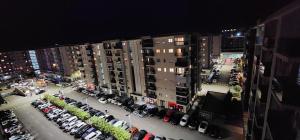 an aerial view of a parking lot in a city at night at City apartment in Podgorica
