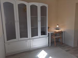 a white cabinet with a desk and a chair in a room at Suite Huelva garden in Aljaraque +28 photos