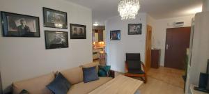 a living room with a couch and pictures on the wall at Apartament Orange Piastowska in Ostróda