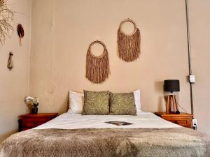 a bedroom with a bed and two wreaths on the wall at Bokatrip El Llano in Oaxaca City