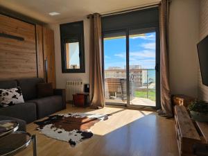 A television and/or entertainment centre at Apartment Beach Front Canet