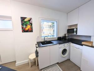 eine Küche mit einer Spüle und einer Waschmaschine in der Unterkunft Superbe appartement et vue - 4 pers - Parking in La Baule