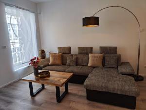 a living room with a couch and a table at Wohlfühloase Köln II in Cologne