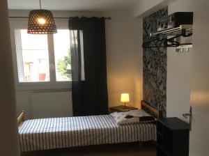 Ένα ή περισσότερα κρεβάτια σε δωμάτιο στο appartement Gilbert