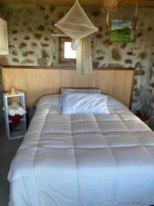 מיטה או מיטות בחדר ב-Quincho Nativo