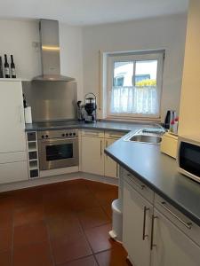 a kitchen with a sink and a counter top at gepflegte Ferienwohnung in ruhiger Lage in Bad Kissingen +5 photos