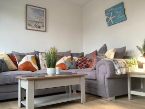 a living room with a couch and a table at J16 Mablethorpe Pet Friendly Chalet in Mablethorpe