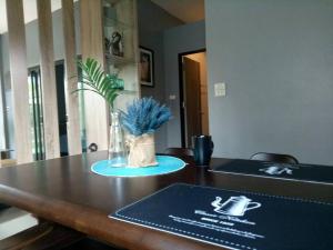 a table with a vase with a plant on it at Happy home Suratthani 152/57 in Amphoe Koksamui