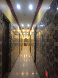 a hallway of a building with a brick wall at Hotel Air View in kolkata