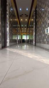 a large room with a stone wall and a concrete floor at Hotel Air View in kolkata