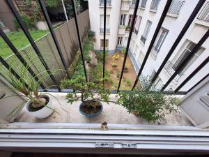 uma vista para uma varanda com vasos de plantas em Read Well - Spare Double Bedroom in Cosy Appartment close to Convention Center in 15th District em Paris