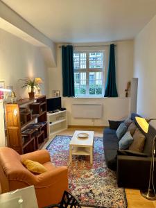 a living room with a couch and a table at Appartement au cœur du vieux Rouen in Rouen