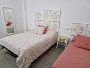a bedroom with a bed and a mirror at La Payana, Sierra de Grazalema Consultar precios en LA PAYANA Prado del Rey in Prado del Rey +34 photos