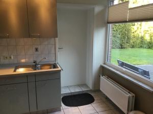 a kitchen with a sink and a window at Haus "Sonnenschein" in Breklum
